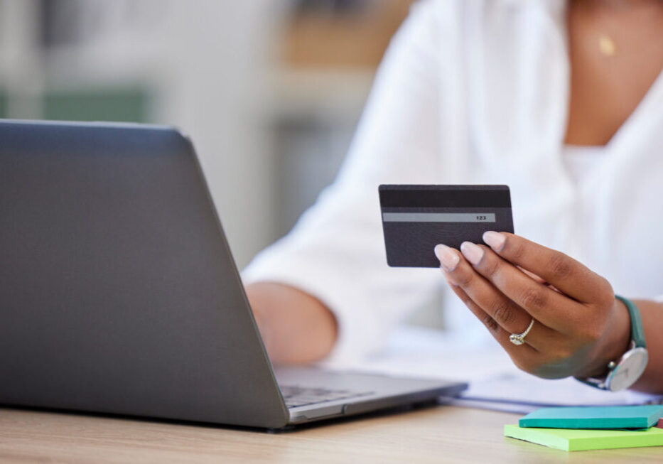 Credit card, laptop and business woman hands for online shopping, financial payment and banking for creative career. Office person typing on computer for web registration, e commerce and fintech loan.