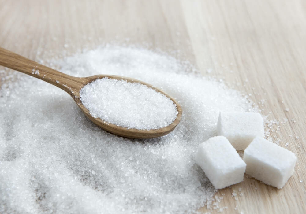 Cubes of sugar with wooden spoon
