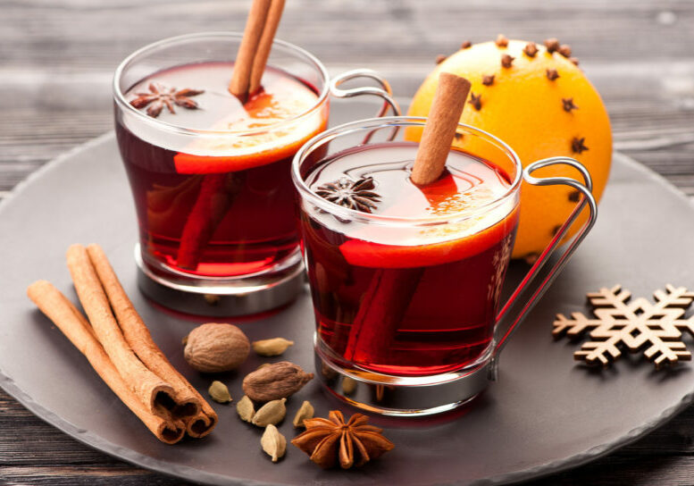 Christmas mulled wine with spices on wooden background