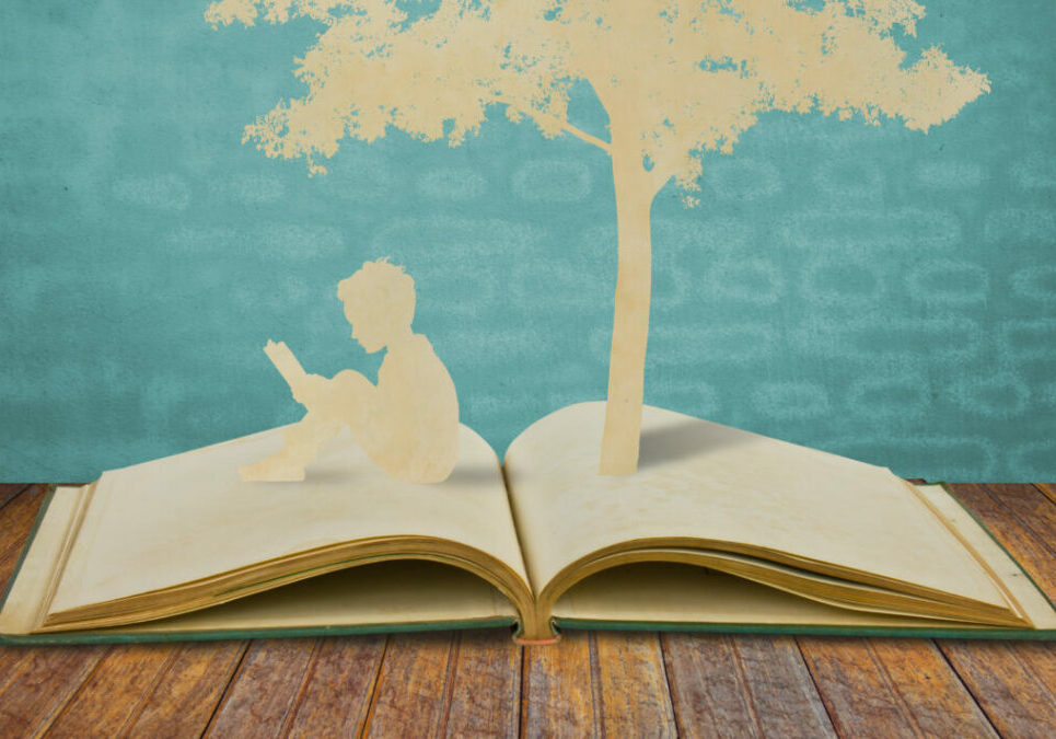 Paper cut of children read a book under tree on old book